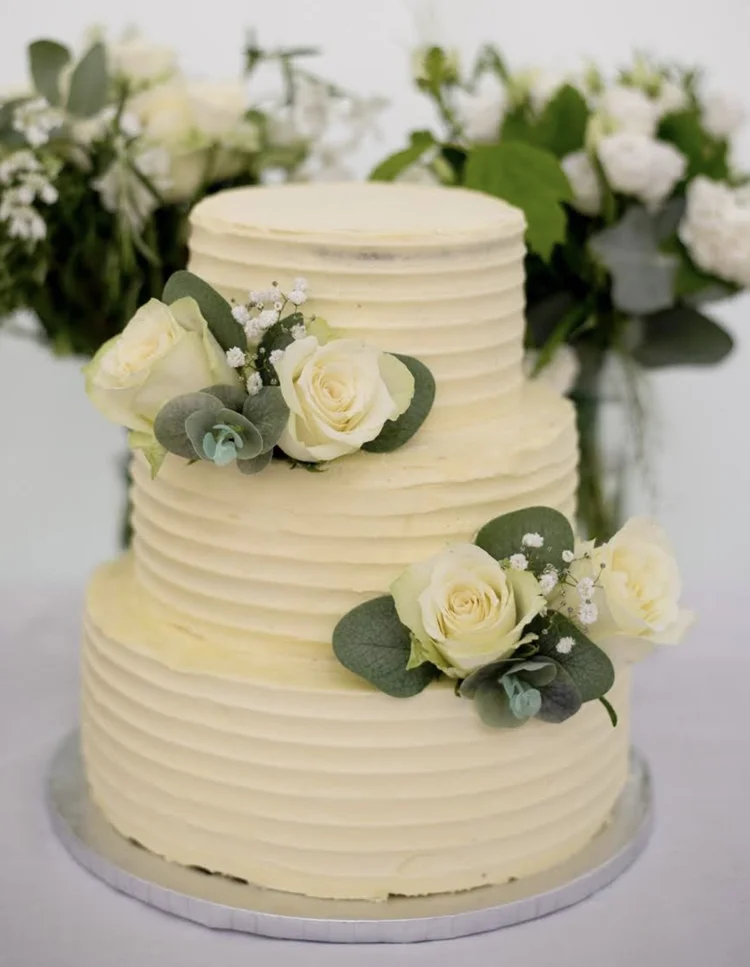 Three-tier buttercream wedding cake with roses, made by PolarBakes in Ebbw Vale, South Wales